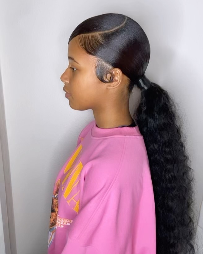 40-ponytail-hairstyles-for-black-women-braided-and-038-natural Low Curly Ponytail with Spiralled Sideburns